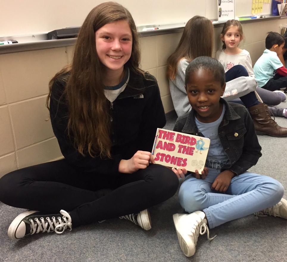 Freshman Early College Academy students read their books to their Meadow's Edge reading buddies
