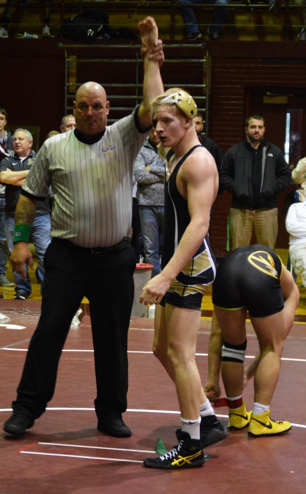 Penn's Jarod Swank has his arm raised by the referee as a symbol of winning.