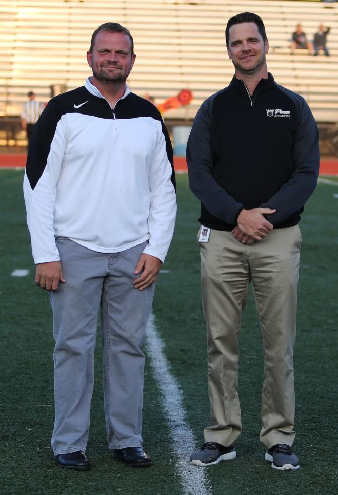 Penn Social Studies instructor Eric Bowers, left, with Penn Principal Sean Galiher at a recognition ceremony at Penn's TCU Freed Field.