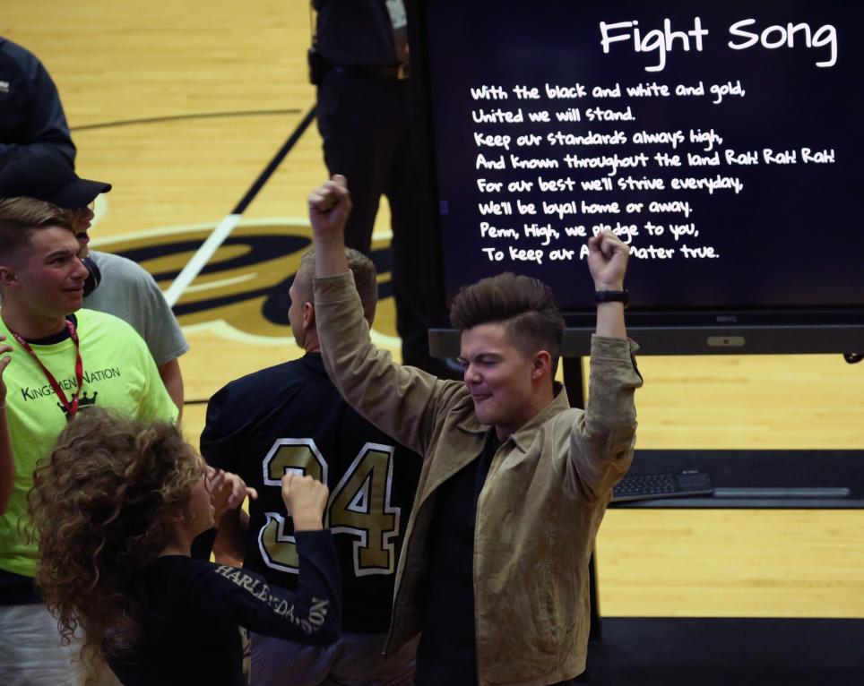 Penn students get in the spirit during the playing of the school song at the Senior Class meeting.