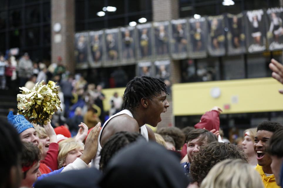 Markus Burton celebrating with Penn students after the game on Jan. 20, 2023