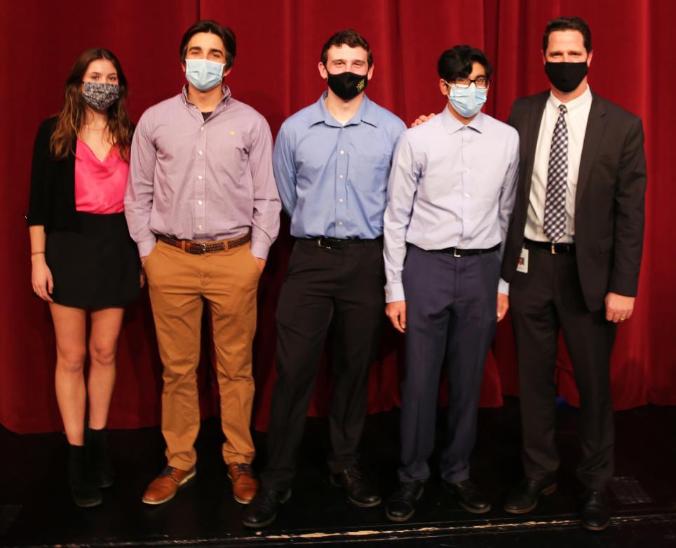 Principal Sean Galiher poses with some National Honor Society inductees.