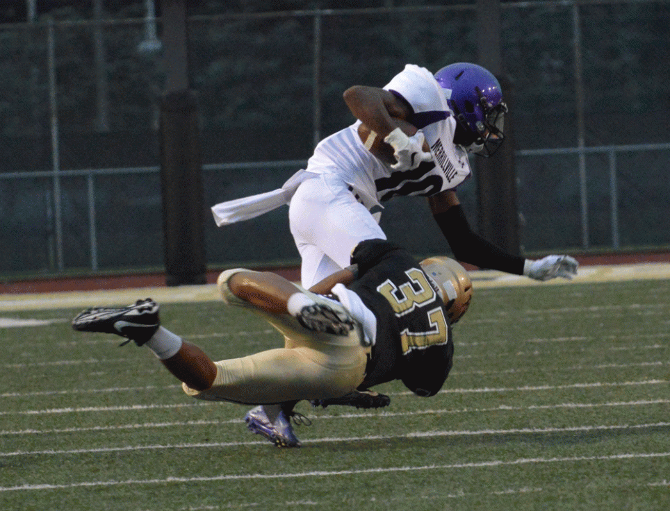 Penn Football player Paul Moala tackles a Merrillville player.