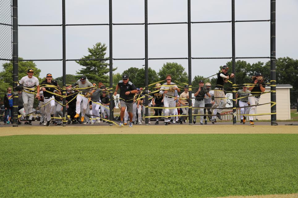 Coach Dikos leads his players out onto the new field (Sept. 10, 2019)