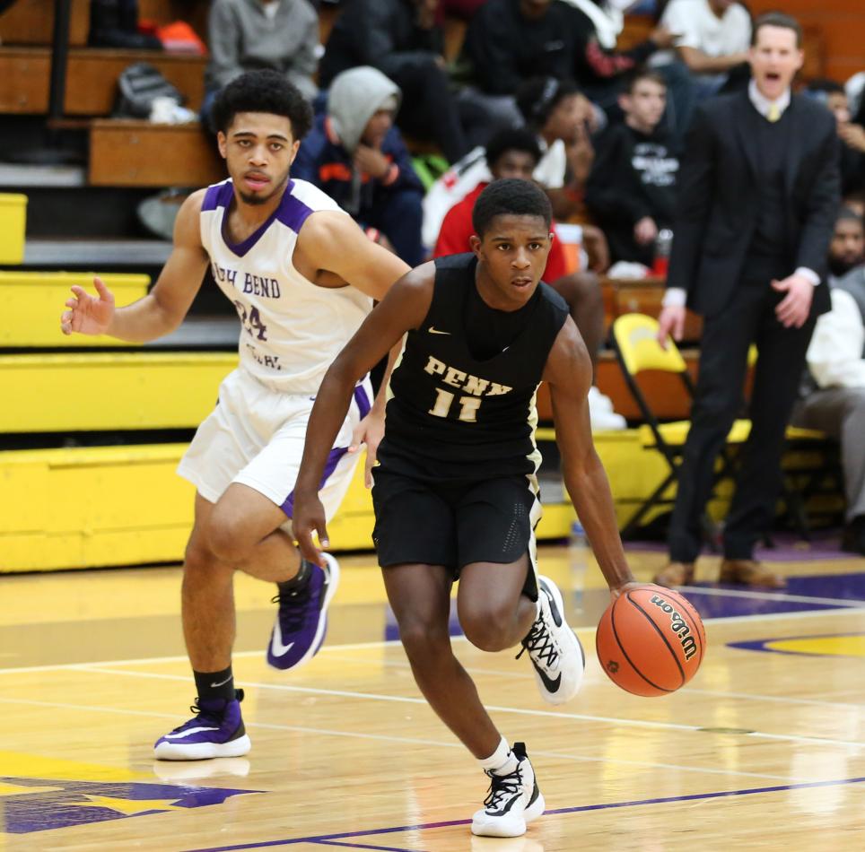 Freshman Point Guard Markus Burton sprints down the court.