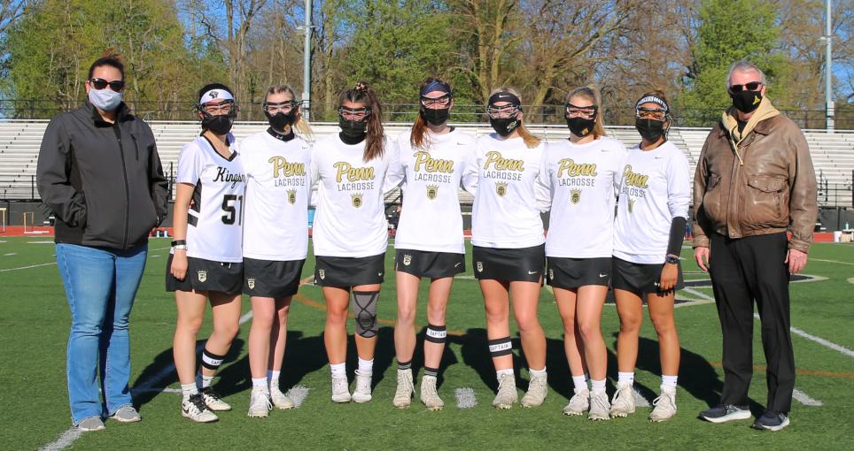 Penn Supt. Dr. Jerry Thacker, far right, Penn Girls Lacrosse Coach Annie Eutsey, far left, and the Penn Girls Lacrosse Seniors.
