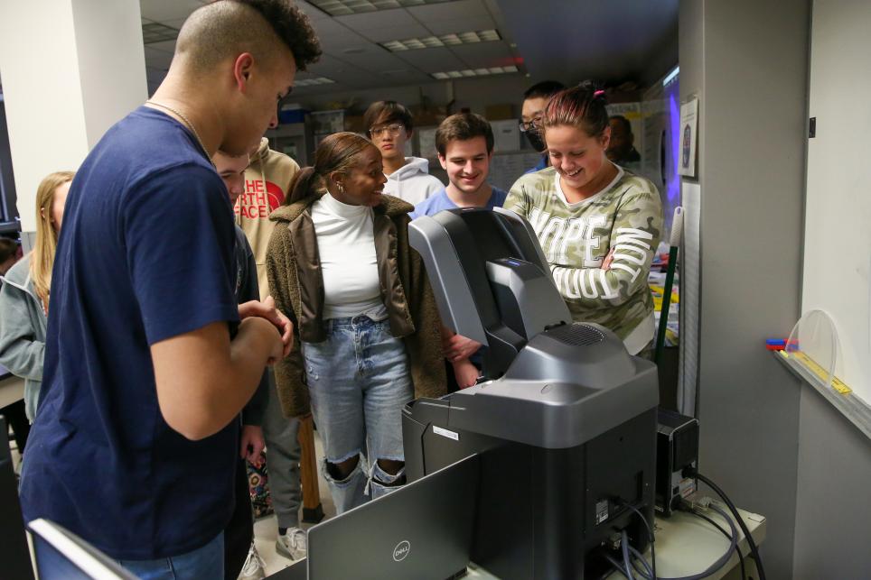 Penn students look at microscope