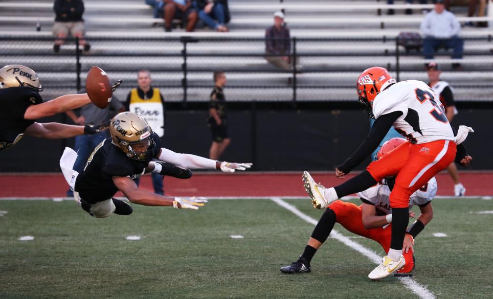 Penn's Nick Hardrict blocks a point-after attempt.