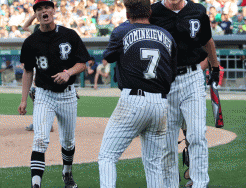 Ryan Lynch is greeted after scoring the tying run in a sixth-inning rally.