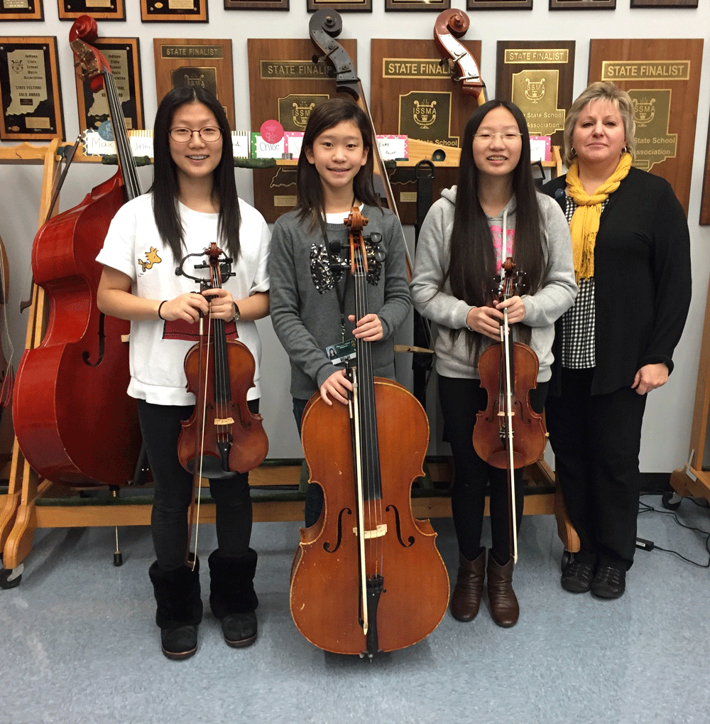 Penn High School's All-State Orchestra selections, from left, Yewon Oh, Darbie Kwan, and Chelsea Chen, with Orchestra Director Anne Tschetter.