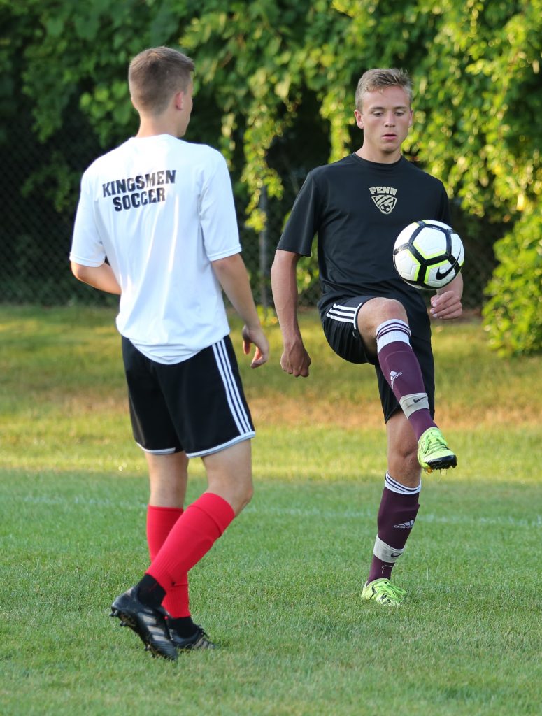 Penn Boys Soccer senior leader Brandon Stahl performs a ball control drill during practice.