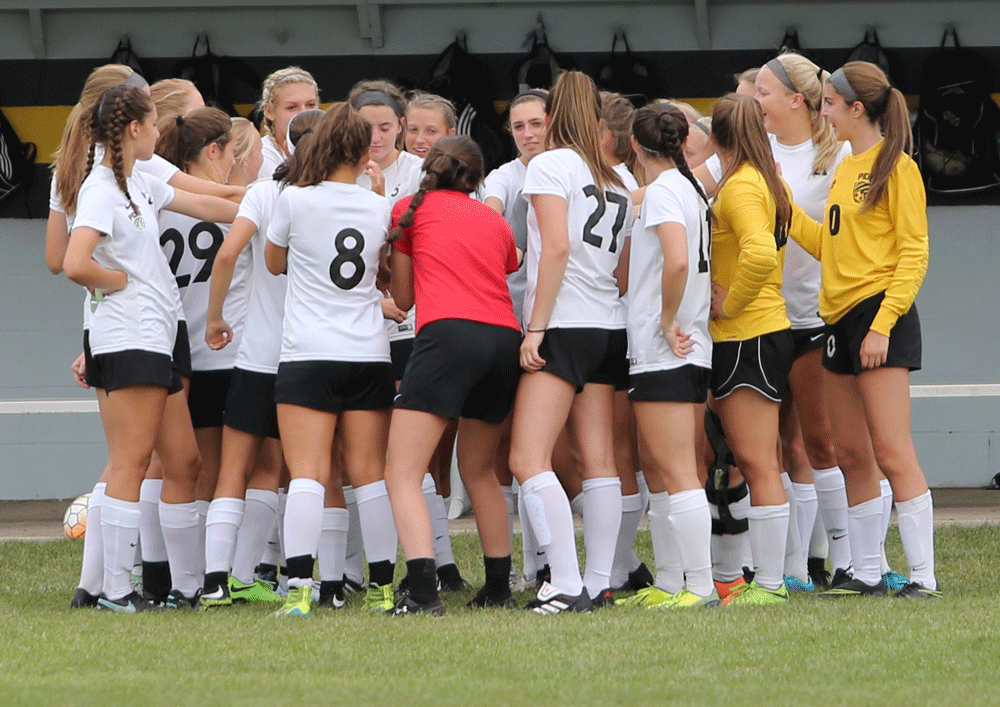 The Penn Girls Soccer Team huddles up before the game.