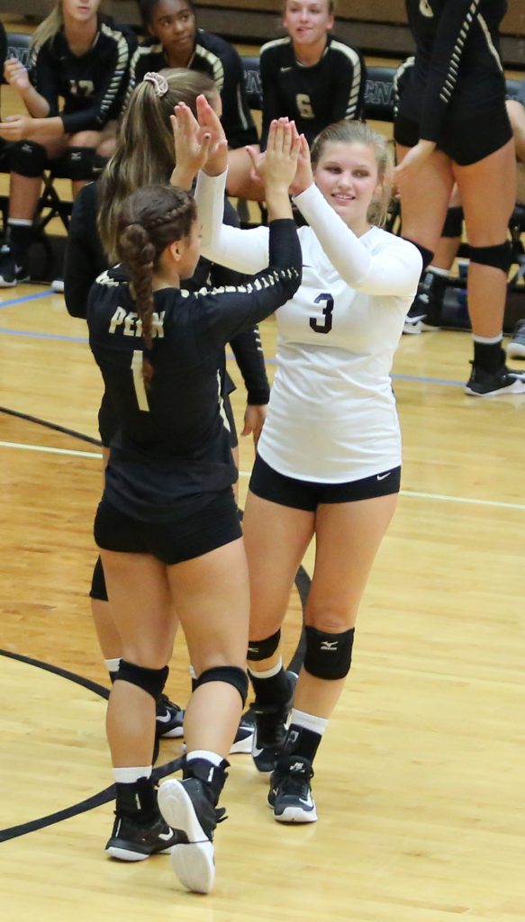 Naomi Willis and Rachel Hickey with high fives after a score.