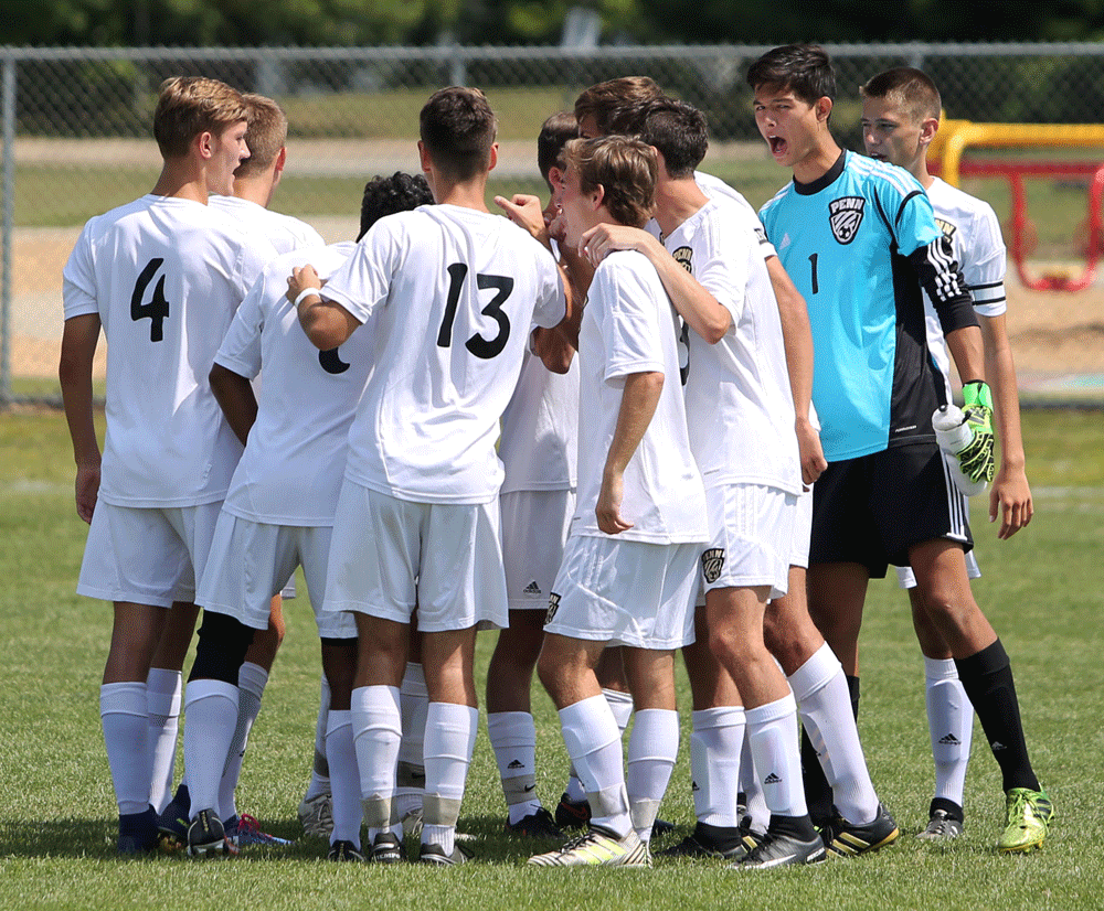 Penn Boys Soccer Team huddles before the game.