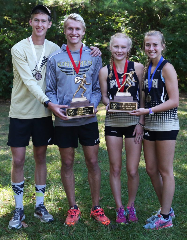 The Penn Boys and Girls Cross Country top finishers hold the Northern Indiana Conference Championships trophies.