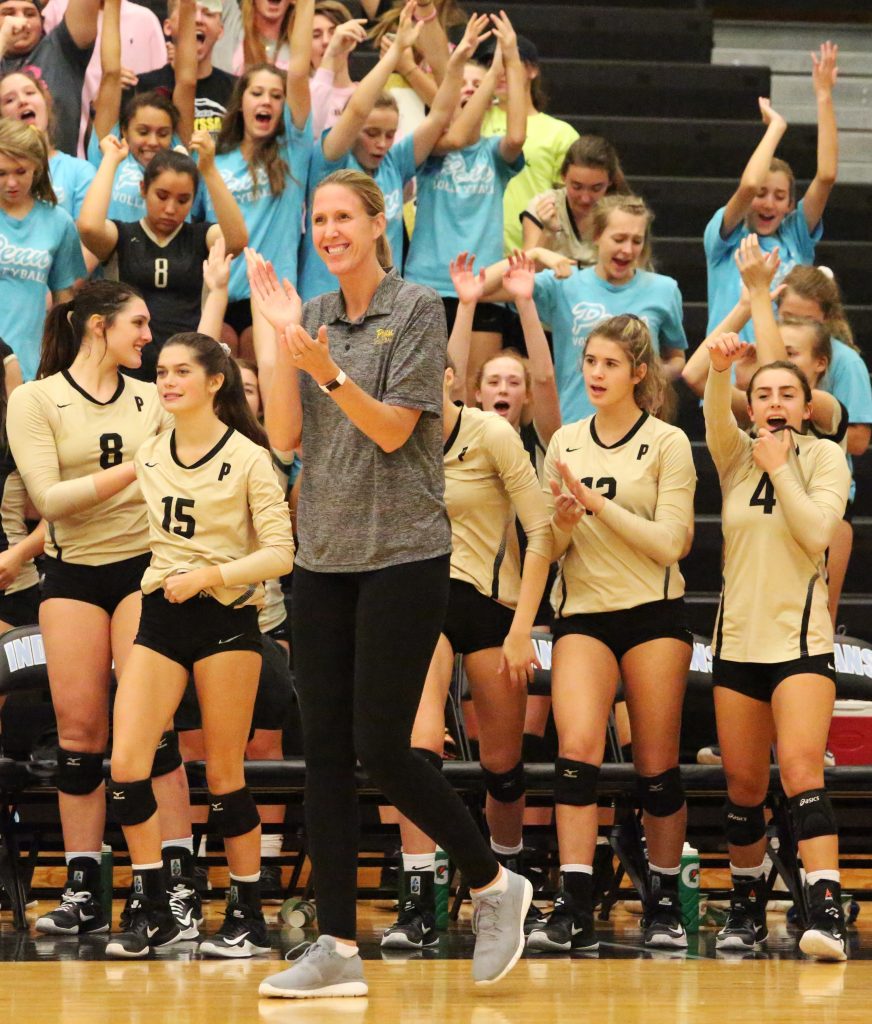 Penn Coach Sarah Hendricks and the Kingsmen celebrate winning the Northern Indiana Conference Championship against South Bend St. Joseph.