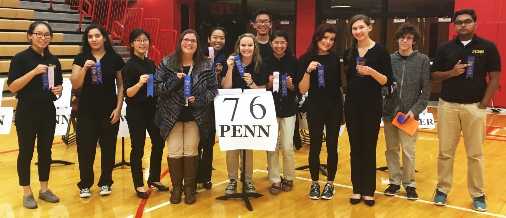 Penn's Spell Bowl Team poses with blue ribbons after winning the Class 1 Area Competition.