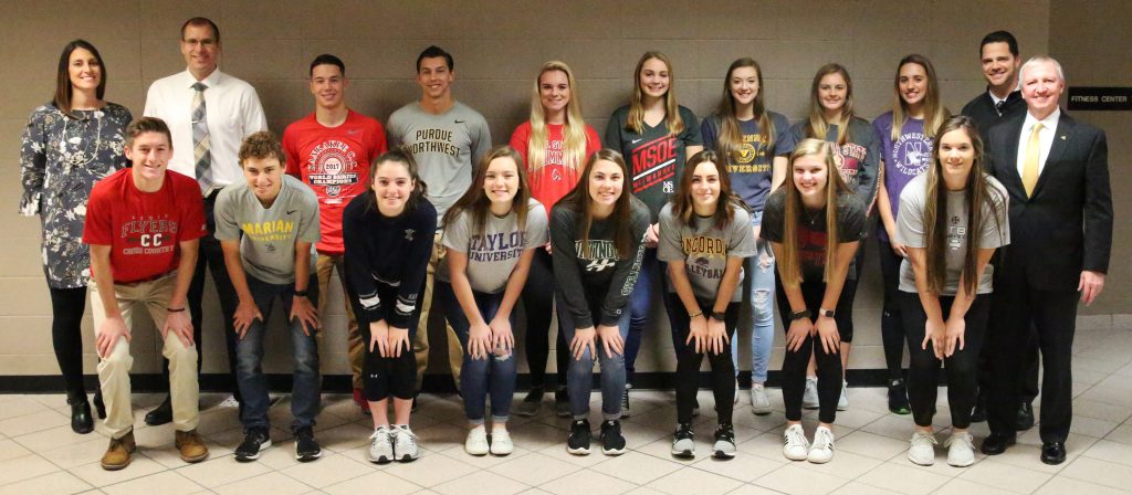 P-H-M Supt. Dr. Jerry Thacker, Principal Sean Galiher, AD Aaron Leniski and AAD Bridget Williams with Penn's 15 student-athletes who participated in the NCAA Signing Day.