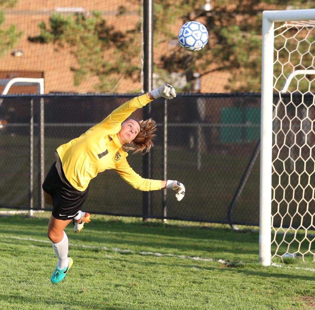 Penn goalie Mackenzie Wood leaps to try to make a save during a pre-game drill.