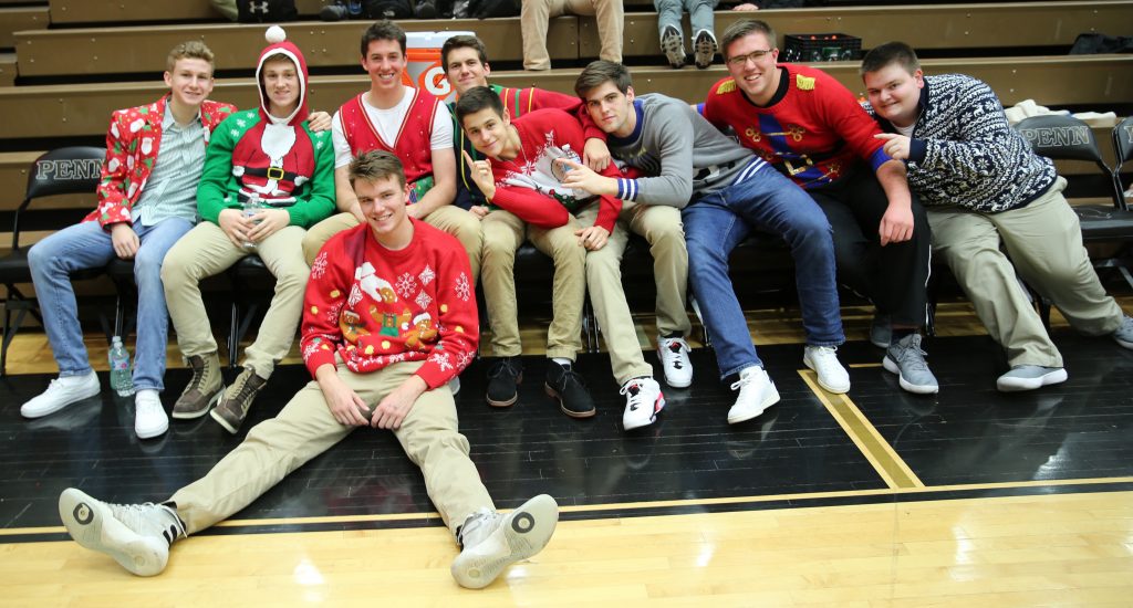 The Kingsmen show off their Holiday sweaters before the game.