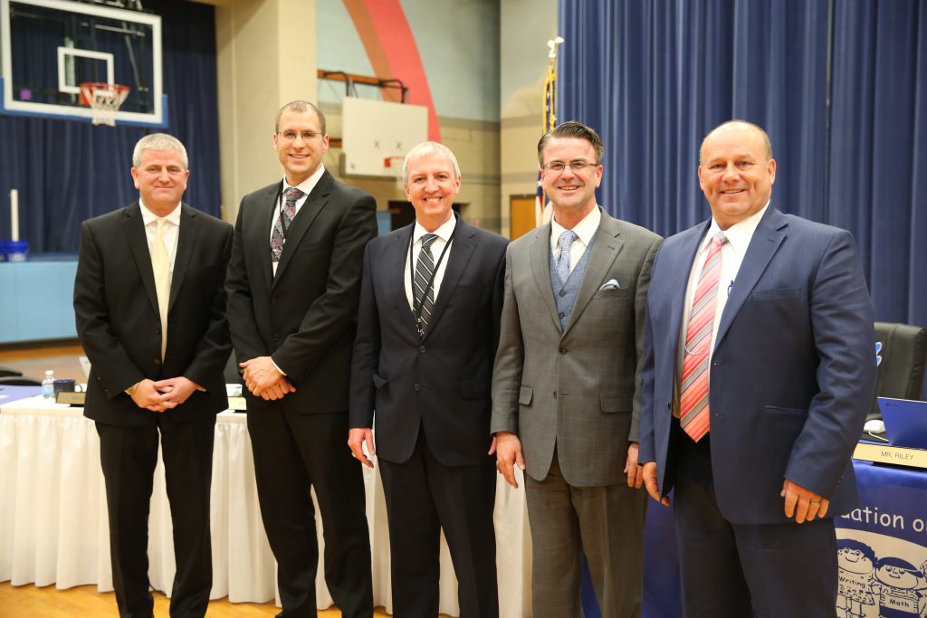 Jeff Hart, Aaron Lenski, Supt. Dr. Jerry Thacker, Board Pres. Chris Riley, and Jerry Hawkins