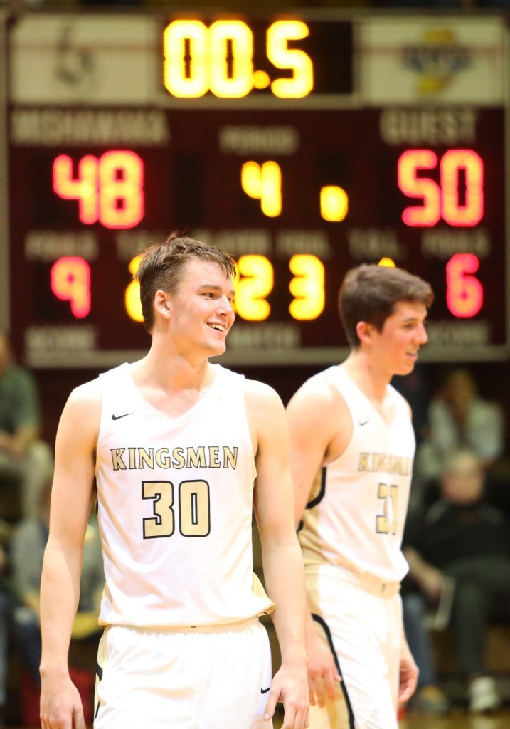 Noah Applegate smiles as the Kingsmen Boys Basketball Team locks up a victory against Mishawaka in the Sectional.