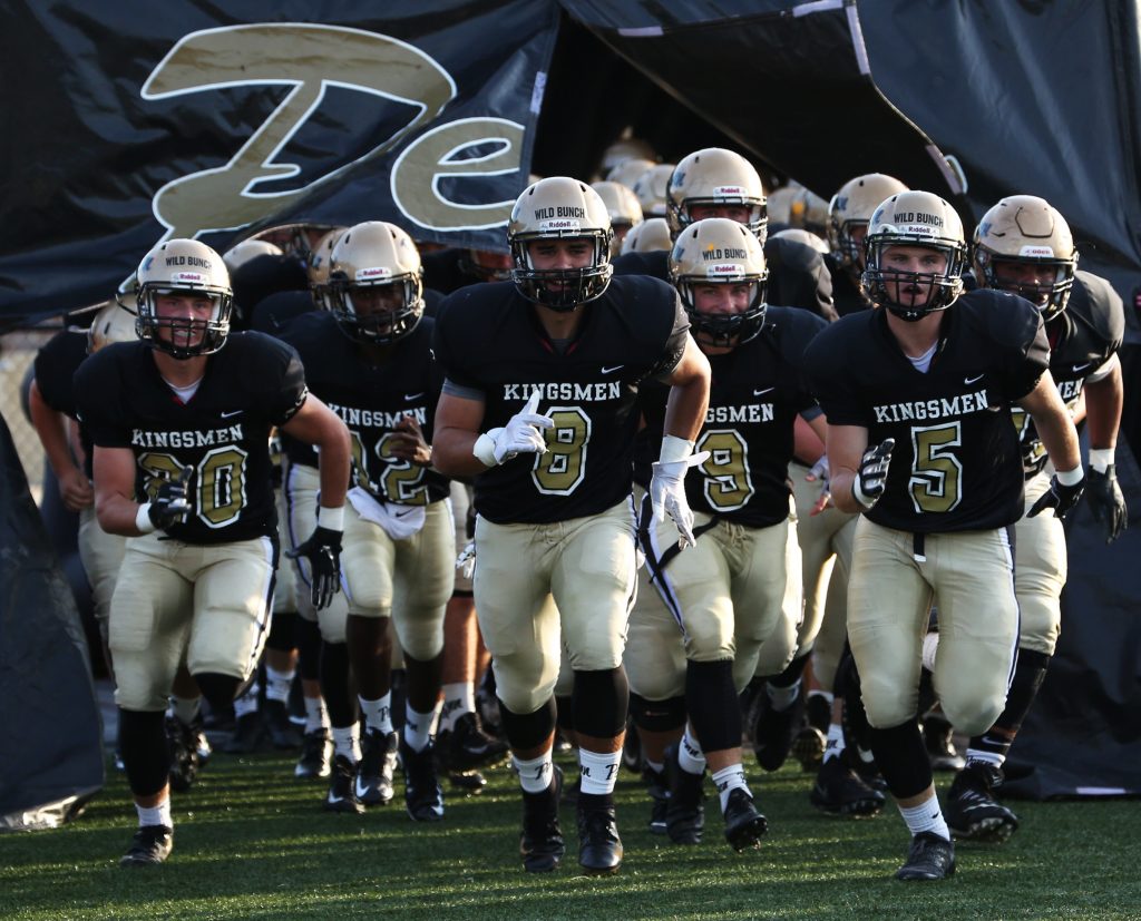 The Penn Football Team takes the field for its game against Brother Rice.