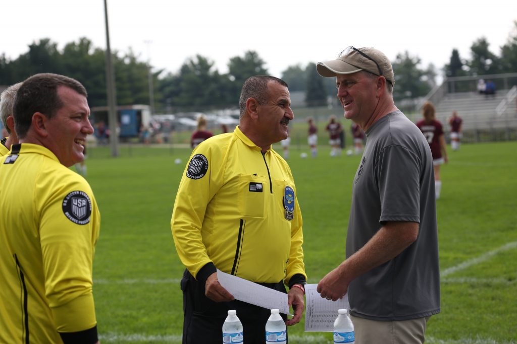 Penn Girls Soccer Coach Jeff Hart, right, talks to an official before a Sectional game.