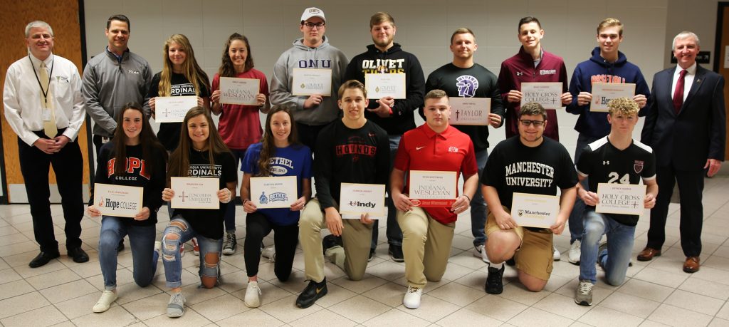 Penn Athletic Director Jeff Hart, Penn Principal Sean Galiher, and P-H-M Supt. Dr. Jerry Thacker and Penn's 15 National Signing Day participants.