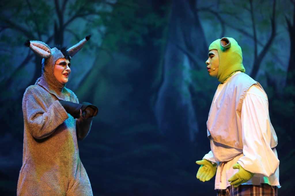 Penn student Sam Robinson, left, as the character Donkey in the play "Shrek"