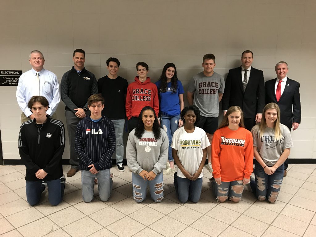 Penn-Harris-Madison School Corp. Supt. Dr. Jerry Thacker, P-H-M COO Aaron Leniski, Penn Principal Sean Galiher, Penn Athletic Director Jeff Hart and the 12 Kingsmen Student-Athletes who signed NCAA/NAIA letters of intent.