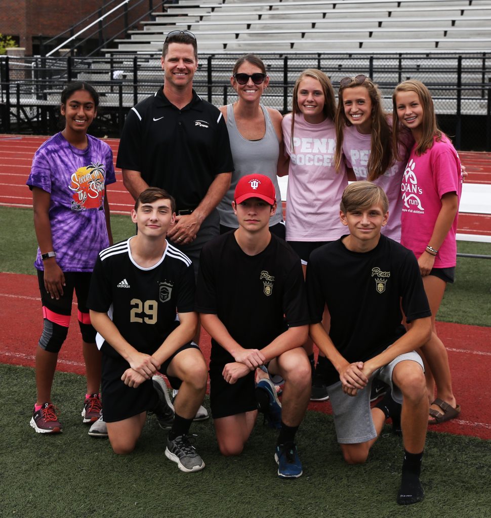 Penn High School Principal Sean Galiher, Assistant Athletic Director Bridget Williams, and Kingsmen student-athletes at the #KingsmenCookout.