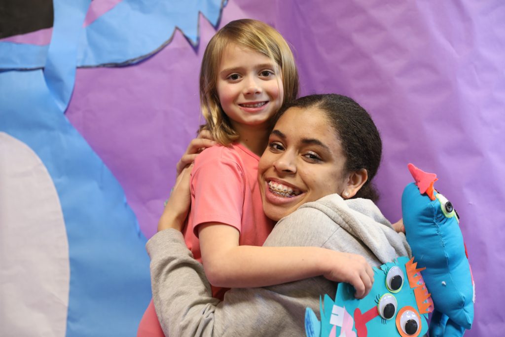 Penn student hugs Bittersweet Kindergartner that she made a Worry Monster for
