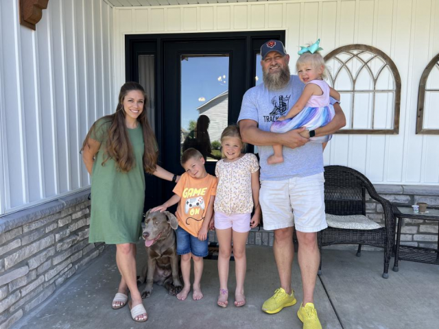 Kylee & Chad Wetzel with their family and their dog Duke
