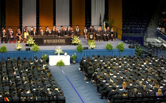 This is a photograph of an indoor graduation ceremony in progress.