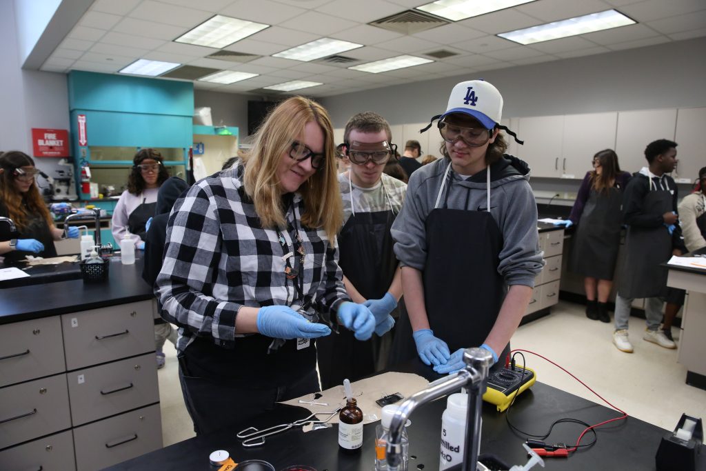 Teacher and student in science lab