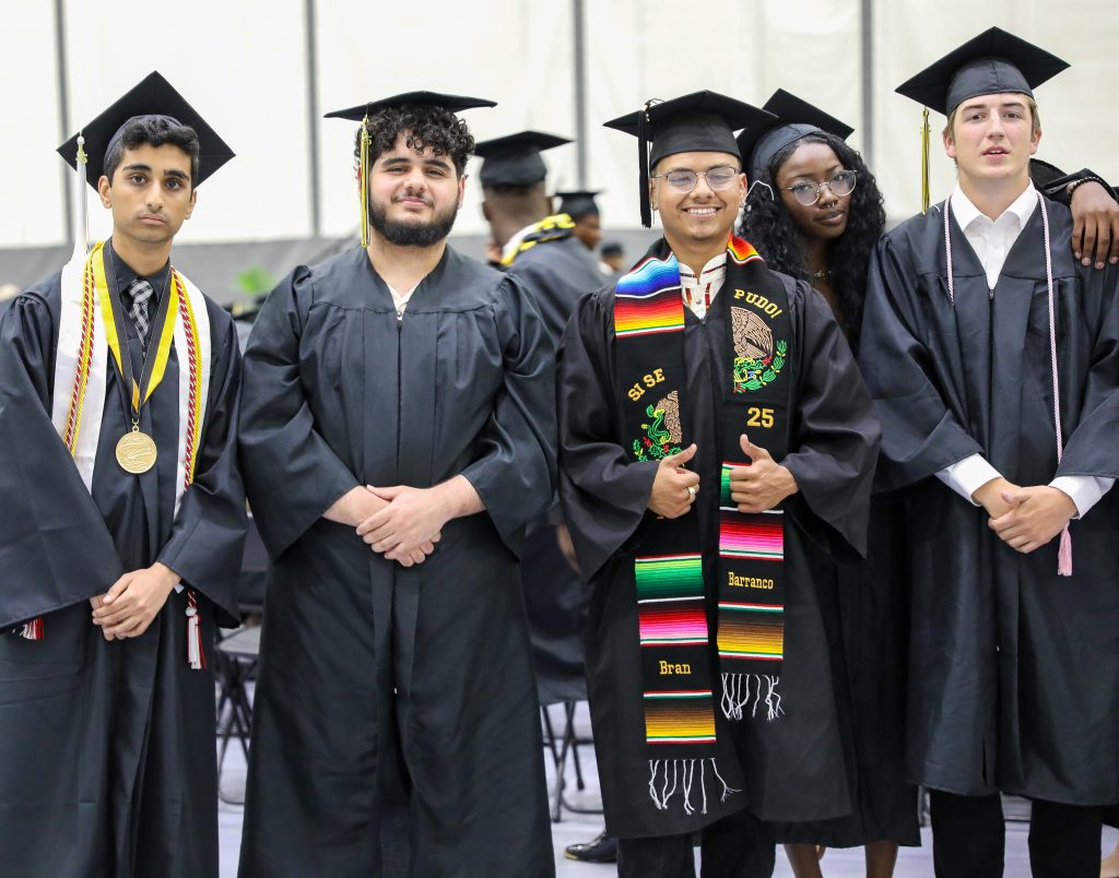 Students dressed in caps & gowns for graduation