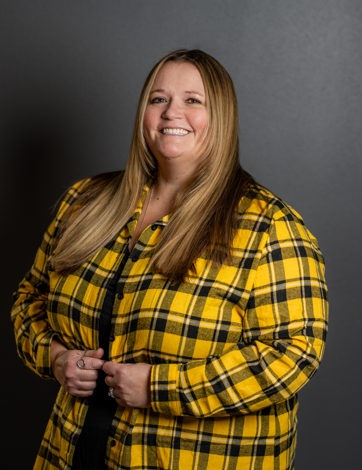 woman in yellow & plaid jacket