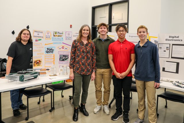 Teacher and students pose for picture