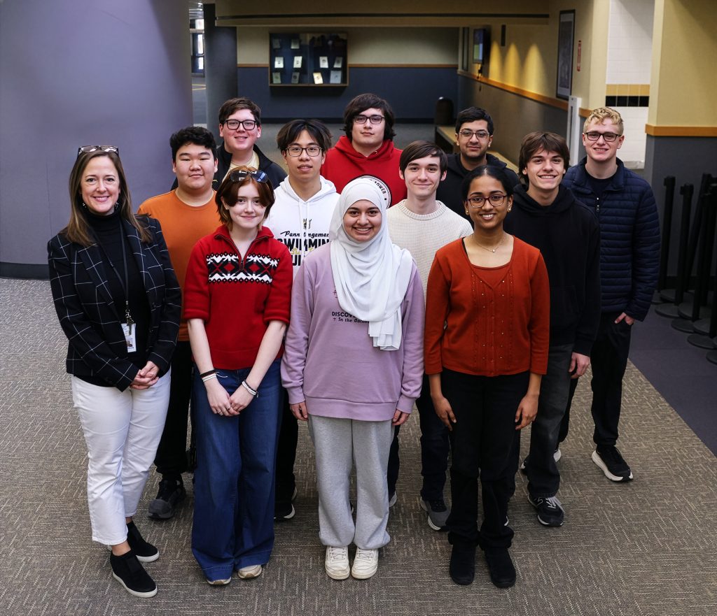Students and principal standing in hallway of Penn High School
