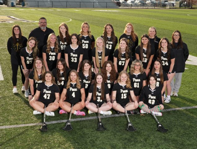 A Girls Lacrosse Team poses for the camera.