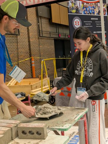 Two people working on a construction project at a convention center.