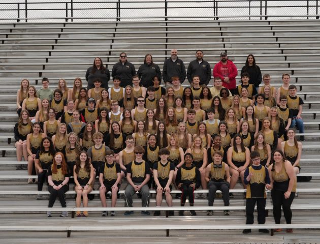 Unified Track & Field Team posing for a group photo on bleachers.