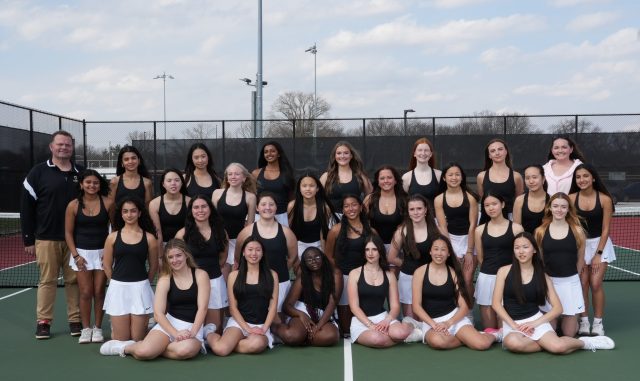 Women's tennis team posing for a group photo.