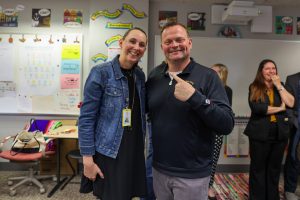 Kelley Watts and Eric Bowers smiling. Bowers pointing at Watts