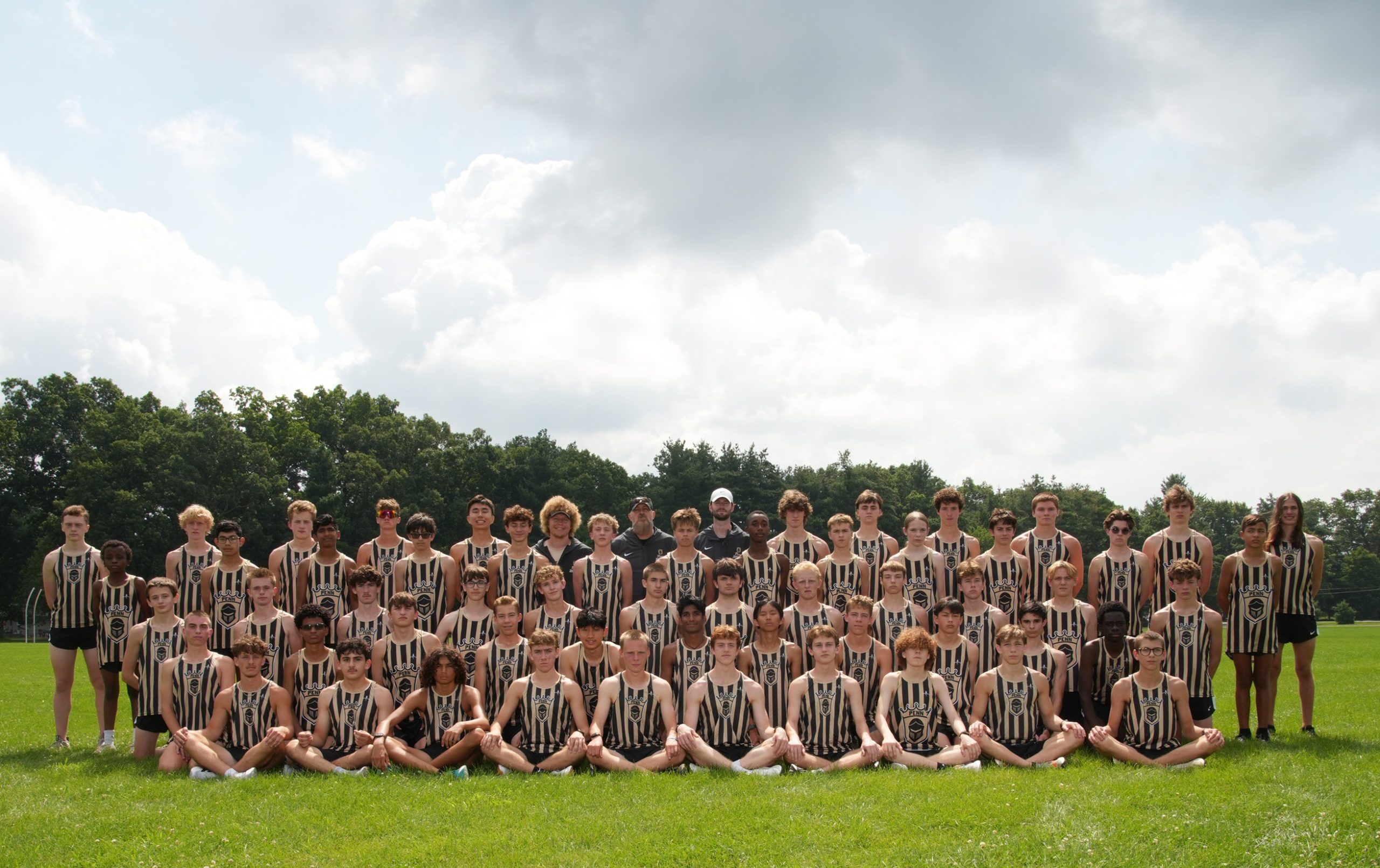 Team of young athletes posing for a group photo in sports uniforms.
