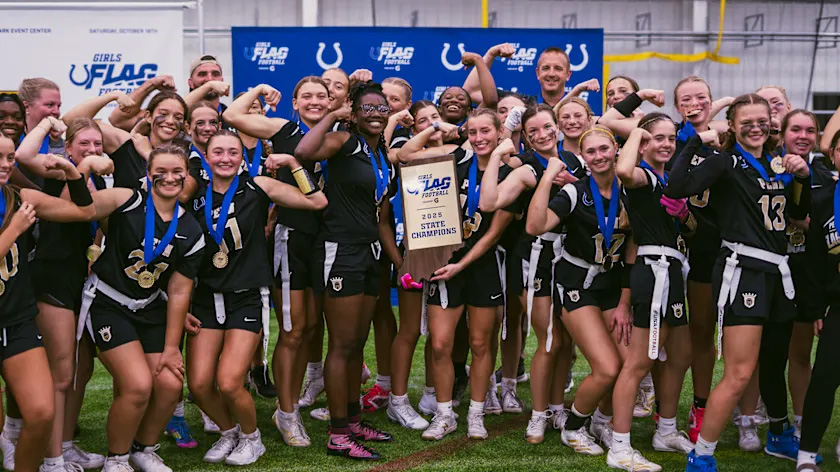 The Penn Girls Flag Football Team poses for a picture with their state championship trophy.