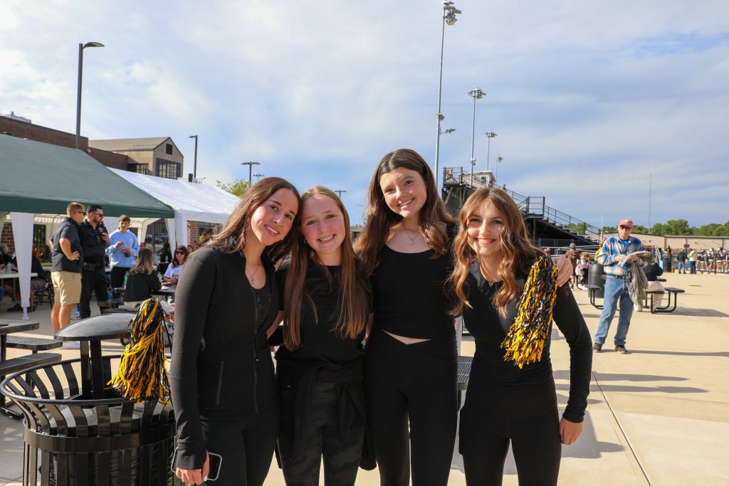 A group of cheerleaders posing for a picture at an event.