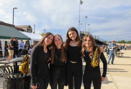 A group of cheerleaders posing for a picture at an event.