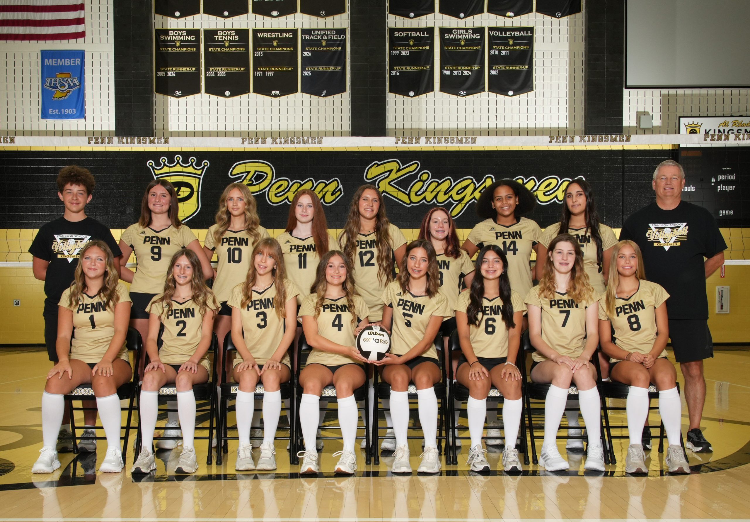 Team of female athletes posing for a team photo in their uniforms.